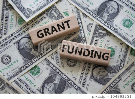 Grant funding symbol. Wooden blocks with words Grant funding. Beautiful dollar background. Business and Grant funding concept. Copy space. Grant funding symbol. Wooden blocks with words Grant funding. Beautiful dollar background. Business and Grant funding concept. Copy space. 104893251