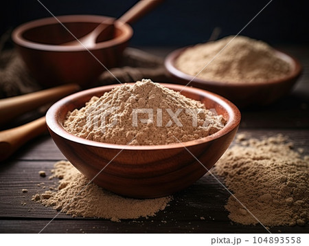 Closeup picture of a bowl with brown psyllium powder flour. Generative AI 104893558