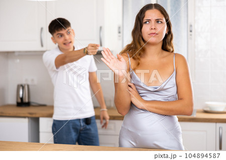 Young husband is dissatisfied with the act of his wife Young husband is dissatisfied with the act of his wife 104894587