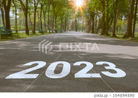 Concept of planning, goal, challenge, new year resolution. 2023 New Year road trip travel and future vision with at sunset. Nature landscape with park road fresh and successful start. Concept of planning, goal, challenge, new year resolution. 2023 New Year road trip travel and future vision with at sunset. Nature landscape with park road fresh and successful start. 104894890