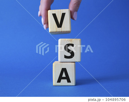 VSA - Volume Spread Analysis symbol. Wooden cubes with word VSA. Businessman hand. Beautiful blue background. Business and Volume Spread Analysis concept. Copy space. VSA - Volume Spread Analysis symbol. Wooden cubes with word VSA. Businessman hand. Beautiful blue background. Business and Volume Spread Analysis concept. Copy space. 104895706