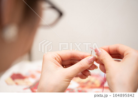 針に糸を通す女性 104895842