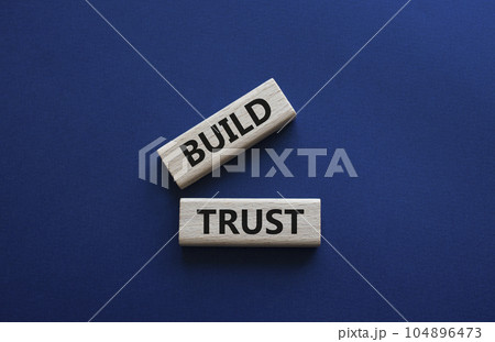 Build trust symbol. Wooden blocks with words Build trust. Beautiful deep blue background. Business and Build trust concept. Copy space. Build trust symbol. Wooden blocks with words Build trust. Beautiful deep blue background. Business and Build trust concept. Copy space. 104896473