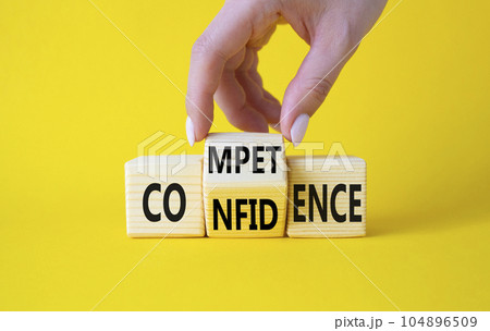Competence and Confidence symbol. Businessman hand turns wooden cubes and changes the words Confidence to Competence. Beautiful yellow background. Business concept. Copy space Competence and Confidence symbol. Businessman hand turns wooden cubes and changes the words Confidence to Competence. Beautiful yellow background. Business concept. Copy space 104896509