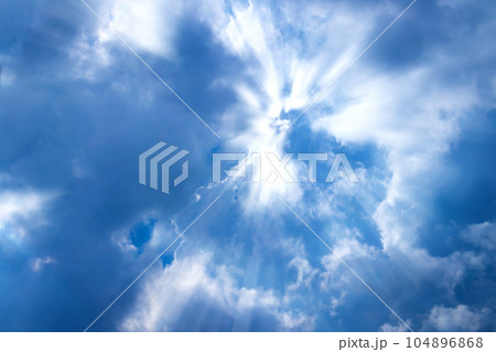 Sunbeam through the cloud on blue sky Sunbeam through the cloud on blue sky 104896868