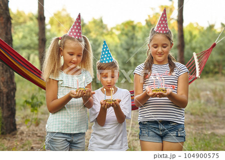Children holding birthday cakes with burning candles. Children holding birthday cakes with burning candles. 104900575