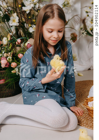 Two girls in a beautiful Easter photo zone with flowers, eggs, chickens and Easter bunnies. Happy Easter holiday. Two girls in a beautiful Easter photo zone with flowers, eggs, chickens and Easter bunnies. Happy Easter holiday. 104902114