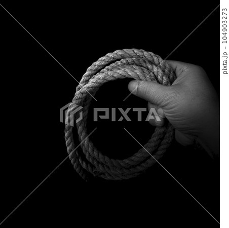 Man's hand holding on to the rope. Hand holding a rope 104903273