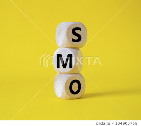 SMO - Social Media Optimization symbol. Wooden blocks with words SMO. Beautiful yellow background. Business and SMO concept. Copy space. 104903758