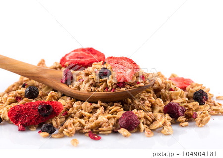 Muesli oat cereals close up background with dry fruits in wooden spoon 104904181