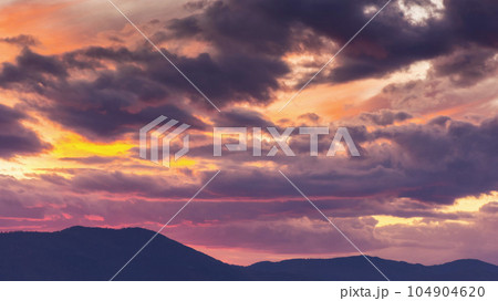 dramatic cloudscape at dusk. sky in colorful evening light. changing weather forecast 104904620