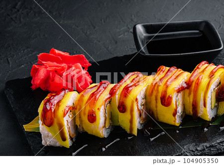 delicious sushi rolls with yellow pickled radish on the plate delicious sushi rolls with yellow pickled radish on the plate 104905350