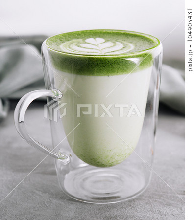 Green matcha latte with pistachios close up Green matcha latte with pistachios close up 104905431