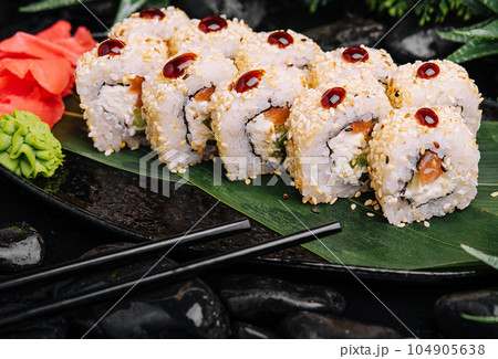 set of fresh sushi rolls with salmon, avocado and sesame seeds set of fresh sushi rolls with salmon, avocado and sesame seeds 104905638