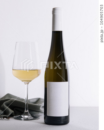 Bottle of wine with a glass of wine 104905703