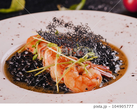 delicious black rice with shrimps in plate delicious black rice with shrimps in plate 104905777