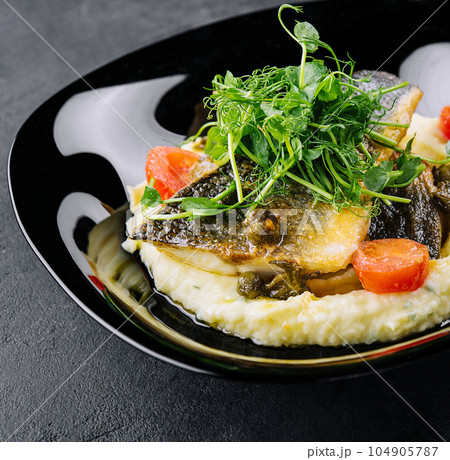 Fried norwegian skrei cod fish filet with mashed potatoes Fried norwegian skrei cod fish filet with mashed potatoes 104905787