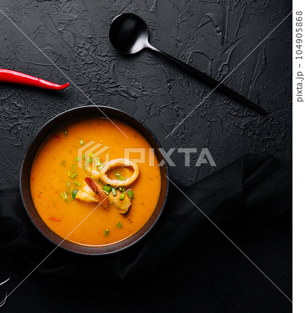 Tom yam seafood soup from above on black stone 104905868