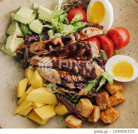 Buddha bowl salad with grilled chicken breast slices 104906350