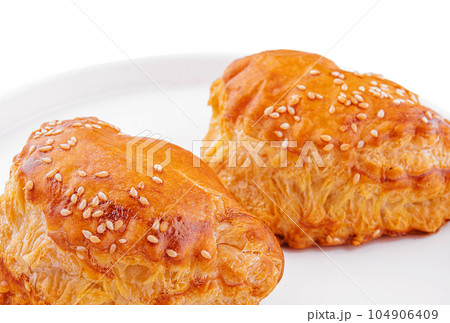 Puff pastry with sesame seeds on white plate Puff pastry with sesame seeds on white plate 104906409