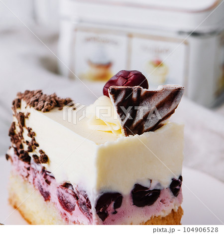 Slice of cherry cheesecake on plate 104906528