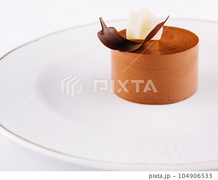 Plate with coffee panna cotta on white Plate with coffee panna cotta on white 104906533