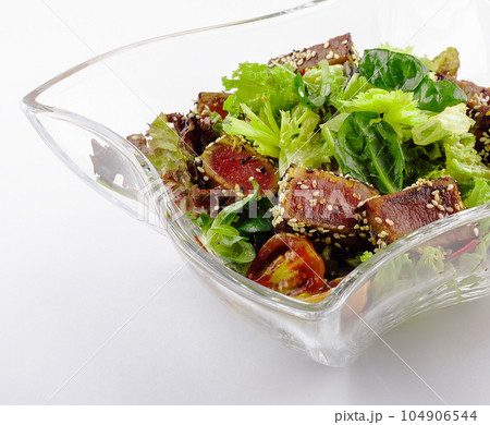Salad with fried tuna on glass plate 104906544