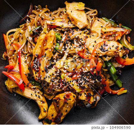 Appetizing asian cuisine chicken and vegetables udon noodles wok 104906590