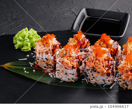 Japanese sushi volcano roll with eel on top and sesame inside 104906617
