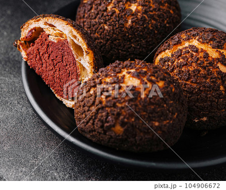 PoofPoof Butterscotch on black plate on stone 104906672