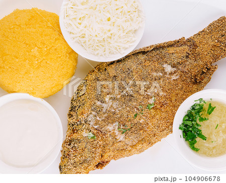 Traditional Moldavian porridge made from hominy and fish with goat cheese 104906678