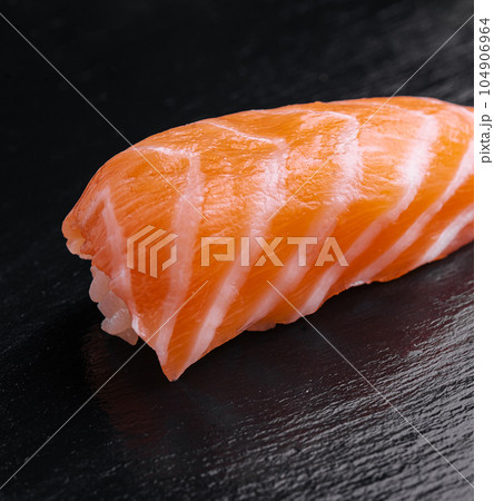 japanese salmon sushi on black wood table japanese salmon sushi on black wood table 104906964