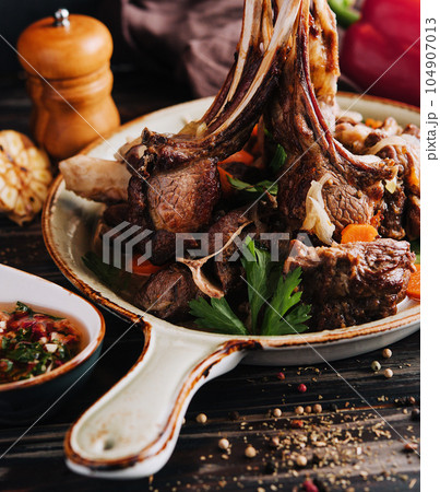 Roasted lamb chops with vegetables Roasted lamb chops with vegetables 104907013