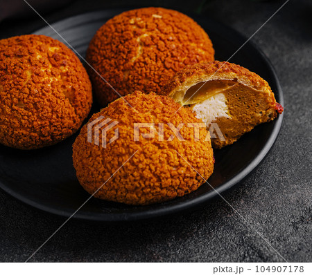 PoofPoof Butterscotch on black plate on stone plate 104907178