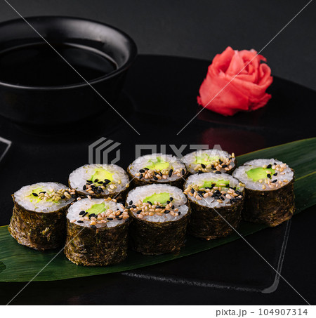 Sushi Maki With Avocado on black plate Sushi Maki With Avocado on black plate 104907314