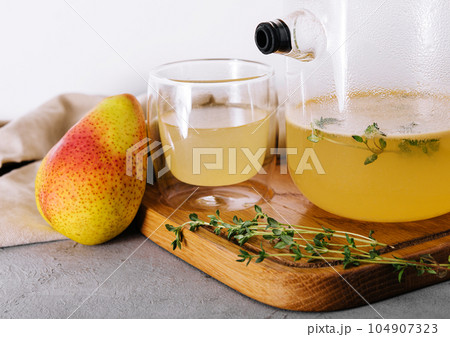 Glass kettle of fresh pear herbal tea Glass kettle of fresh pear herbal tea 104907323