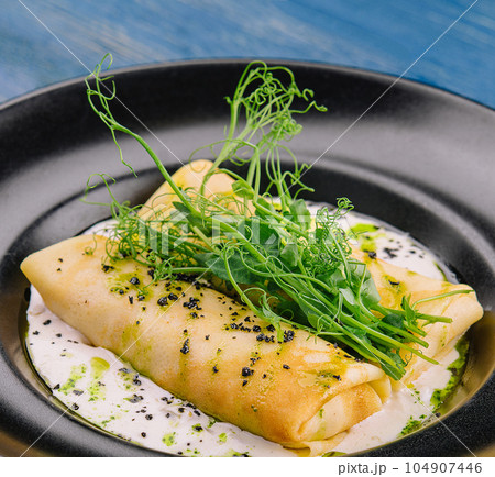 Pancakes with meat and mushroom sauce 104907446