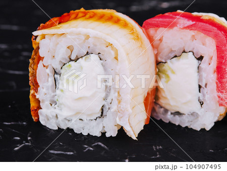 Eel and tuna sushi rolls on stone 104907495
