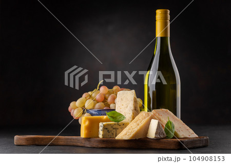 Various cheese on board and white wine 104908153
