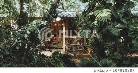 small wooden cottage hidden in wild deep tropical green forest vintage wide for living in nature banner concept 104910587