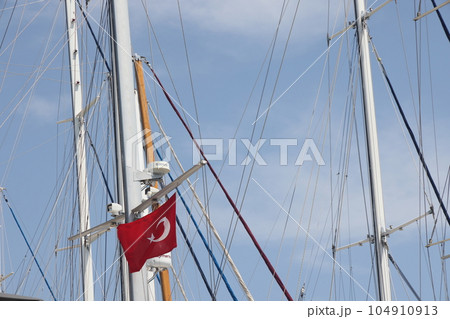 Bodrum, Turkey, May 2023, masts of white yachts against the background of the blue sea, Aegean Sea. 104910913