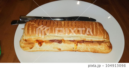 Grilled smoked beef mushroom Panini or sandwich served with white plate on the wooden table. 104913098
