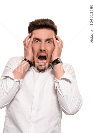 Vertical shot of stupefied stunned shocked young male keeps mouth widely opened, being surprised and very emotional, expresses great surprisment. 104913596