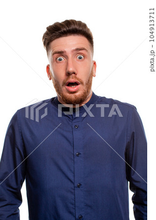 Vertical shot of stupefied stunned shocked young male keeps mouth widely opened, being surprised and very emotional, expresses great surprisment. 104913711