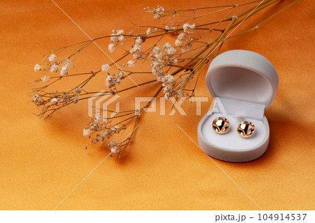 Golden earrings and jewelry box on table close up 104914537