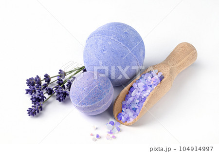 Lavender bath bombs and sea salt with lavender flowers on white background. Herbal healthy beauty spa products. Aromatherapy and herbal medicine for body treatment. 104914997