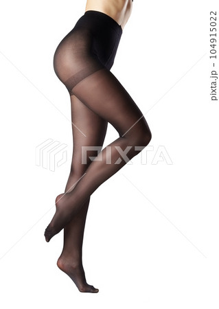 Legs of a woman in black capron tights on white background 104915022