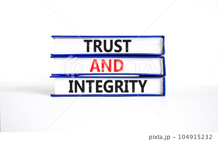 Trust and integrity symbol. Concept words Trust and integrity on books. Beautiful white table white background. Business, psychological and trust and integrity concept. Copy space. 104915232