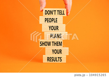 Plan or result symbol. Concept words Do not tell people your plans show them your results on wooden block. Beautiful orange table orange background. Business plan or result concept. Copy space. 104915265