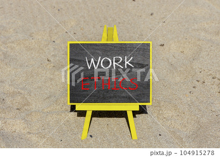 Work ethics symbol. Concept words Work ethics on beautiful black chalk blackboard on a beautiful sand beach background. Business and Work ethics concept. Copy space. Work ethics symbol. Concept words Work ethics on beautiful black chalk blackboard on a beautiful sand beach background. Business and Work ethics concept. Copy space. 104915278